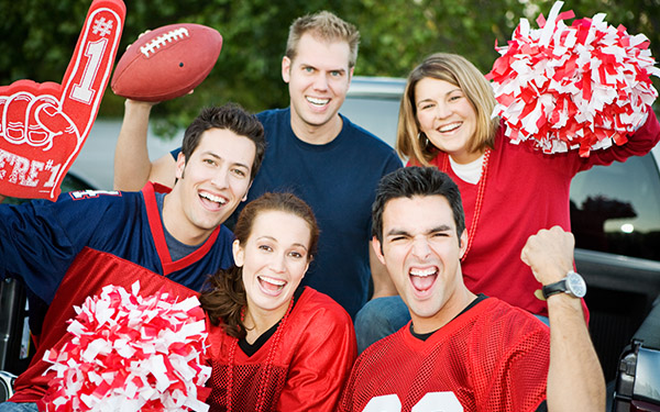 Image of college football fans with college football merch.