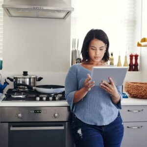 woman in kitchen on ipad