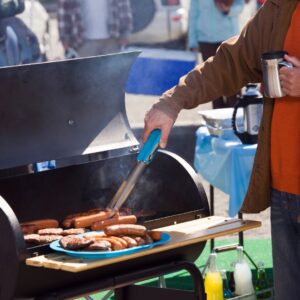 person grilling at a tailgate party