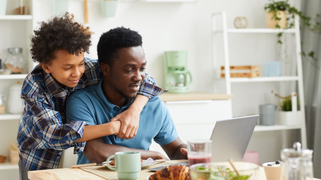 Father and son shopping online together