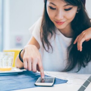 Woman scrolling through Jenkins Enterprise website on her cell phone